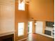 Living room features a fireplace, hardwood floors, and is adjacent to the kitchen, with high ceilings and natural light at 1972 Ashwood Grove Dr, Snellville, GA 30078