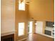 Living room featuring soaring ceilings, fireplace, windows, and a ceiling fan at 1972 Ashwood Grove Dr, Snellville, GA 30078
