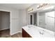Bathroom featuring a dual sink vanity, large mirror, and a combined shower and bathtub at 222 Alton Cir, Villa Rica, GA 30180