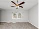 Large primary bedroom featuring new carpet, a ceiling fan, and bright windows at 222 Alton Cir, Villa Rica, GA 30180