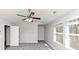 Large secondary bedroom with new carpet, bright windows, a ceiling fan, and neutral walls at 222 Alton Cir, Villa Rica, GA 30180