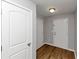 Hallway featuring neutral paint, modern light fixture, and wood floors at 222 Alton Cir, Villa Rica, GA 30180
