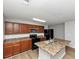 Kitchen with island, dark cabinets, stainless steel microwave, and black appliances at 222 Alton Cir, Villa Rica, GA 30180