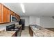 Kitchen featuring an island with double sink, dark cabinets, and black appliances at 222 Alton Cir, Villa Rica, GA 30180