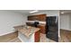 Kitchen with island, dark appliances and wood cabinets at 222 Alton Cir, Villa Rica, GA 30180