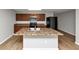 Kitchen with island, wood cabinets, and stainless steel microwave at 222 Alton Cir, Villa Rica, GA 30180