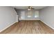 Bright living room featuring wood flooring, a ceiling fan, and natural light streaming through windows at 222 Alton Cir, Villa Rica, GA 30180
