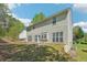 The back of the house, featuring a large backyard, a small patio and lush green grass at 3936 Toccoa Falls Dr, Duluth, GA 30097