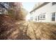Spacious backyard with grass, trees, and the home's exterior at 3936 Toccoa Falls Dr, Duluth, GA 30097