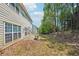 View of the back of the house with a patio, lawn, and natural wooded area to the side at 3936 Toccoa Falls Dr, Duluth, GA 30097