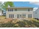 Back exterior view of home features a spacious backyard with mature trees and a patio area at 3936 Toccoa Falls Dr, Duluth, GA 30097