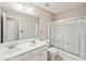 Bathroom with a double sink vanity and shower with sliding glass doors at 3936 Toccoa Falls Dr, Duluth, GA 30097