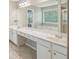 Bathroom features a long vanity with sinks, a large mirror and a bright window at 3936 Toccoa Falls Dr, Duluth, GA 30097