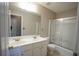 Bathroom featuring double sink vanity with large mirror and shower with sliding glass doors at 3936 Toccoa Falls Dr, Duluth, GA 30097