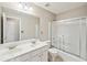 Bathroom with double sink vanity and a shower-tub combination with sliding glass doors at 3936 Toccoa Falls Dr, Duluth, GA 30097