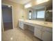 Bathroom featuring double sinks with plenty of counter space and a large mirror at 3936 Toccoa Falls Dr, Duluth, GA 30097