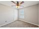 Bedroom with neutral walls, plush carpet, and a ceiling fan with a light fixture at 3936 Toccoa Falls Dr, Duluth, GA 30097
