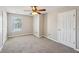Spacious bedroom with neutral walls, plush carpet, and ceiling fan with a light fixture at 3936 Toccoa Falls Dr, Duluth, GA 30097