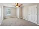 Neutral bedroom featuring cozy carpet, a ceiling fan and a window with views at 3936 Toccoa Falls Dr, Duluth, GA 30097