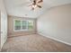 Large bedroom with vaulted ceiling, neutral carpet, and natural lighting at 3936 Toccoa Falls Dr, Duluth, GA 30097