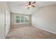 A primary bedroom with vaulted ceiling, neutral carpet, and large window at 3936 Toccoa Falls Dr, Duluth, GA 30097