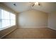 Bright, spacious bedroom with vaulted ceilings, carpet flooring, and a modern ceiling fan at 3936 Toccoa Falls Dr, Duluth, GA 30097