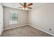Bedroom with neutral walls, carpet, ceiling fan, and a bright window at 3936 Toccoa Falls Dr, Duluth, GA 30097