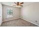 Bedroom featuring neutral walls, plush carpet, and a window with natural light at 3936 Toccoa Falls Dr, Duluth, GA 30097