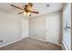 Carpeted bedroom with neutral colors and two entry doors at 3936 Toccoa Falls Dr, Duluth, GA 30097