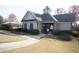 Charming clubhouse with neutral siding, arched windows, and lush landscaping offers a welcoming community space at 3936 Toccoa Falls Dr, Duluth, GA 30097