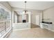 Bright dining space with large windows, tile flooring, built-in desk, and view into the living room at 3936 Toccoa Falls Dr, Duluth, GA 30097