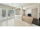 Bright dining room with tile, natural light, access to the patio, and a view of the living room fireplace at 3936 Toccoa Falls Dr, Duluth, GA 30097