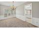 Open dining room featuring wainscoting detail, chandelier and a large window at 3936 Toccoa Falls Dr, Duluth, GA 30097