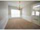 Cozy dining room with wainscotting and a chandelier, adjacent to the kitchen at 3936 Toccoa Falls Dr, Duluth, GA 30097