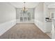 A dining room with plush carpet, large window, and wainscotting details at 3936 Toccoa Falls Dr, Duluth, GA 30097