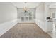 Formal dining room with wainscoting, chandelier, and neutral carpet at 3936 Toccoa Falls Dr, Duluth, GA 30097