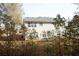 Rear view of home with large windows, siding, and partial view of yard and trees at 3936 Toccoa Falls Dr, Duluth, GA 30097