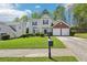 Two-story home boasting a lush lawn, two-car garage, and welcoming curb appeal at 3936 Toccoa Falls Dr, Duluth, GA 30097