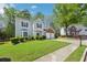 Well-maintained two-story residence with a two-car garage, green lawn, and inviting facade at 3936 Toccoa Falls Dr, Duluth, GA 30097