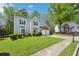 Beautiful two-story home with blue shutters, brick accents, well-manicured lawn, and a two-car garage at 3936 Toccoa Falls Dr, Duluth, GA 30097