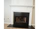 Close-up of fireplace with white mantel and black trim. Logs are visible inside the firebox at 3936 Toccoa Falls Dr, Duluth, GA 30097
