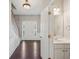 Welcoming foyer with hardwood floors, wainscoting, and a glimpse of the half-bath at 3936 Toccoa Falls Dr, Duluth, GA 30097
