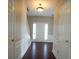 Inviting foyer with hardwood floors, wainscoting, and a view of the front door at 3936 Toccoa Falls Dr, Duluth, GA 30097