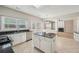 Stylish kitchen featuring white cabinetry, island with granite countertops, and stainless steel dishwasher at 3936 Toccoa Falls Dr, Duluth, GA 30097