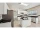 Bright kitchen with granite countertops, a kitchen island, and stainless steel appliances at 3936 Toccoa Falls Dr, Duluth, GA 30097
