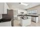Bright eat-in kitchen featuring stainless steel appliances, a kitchen island, and black granite countertops at 3936 Toccoa Falls Dr, Duluth, GA 30097