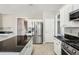 Bright kitchen with granite countertops, stainless steel appliances, and tile flooring at 3936 Toccoa Falls Dr, Duluth, GA 30097