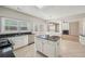 Spacious eat-in kitchen features granite countertops, tile floor, island, and stainless steel dishwasher at 3936 Toccoa Falls Dr, Duluth, GA 30097