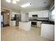 Modern kitchen featuring stainless steel appliances, granite countertops, center island, and an open layout to the living area at 3936 Toccoa Falls Dr, Duluth, GA 30097