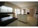 Bright kitchen with stainless steel appliances, granite countertops, large window, and an open layout into the living area at 3936 Toccoa Falls Dr, Duluth, GA 30097